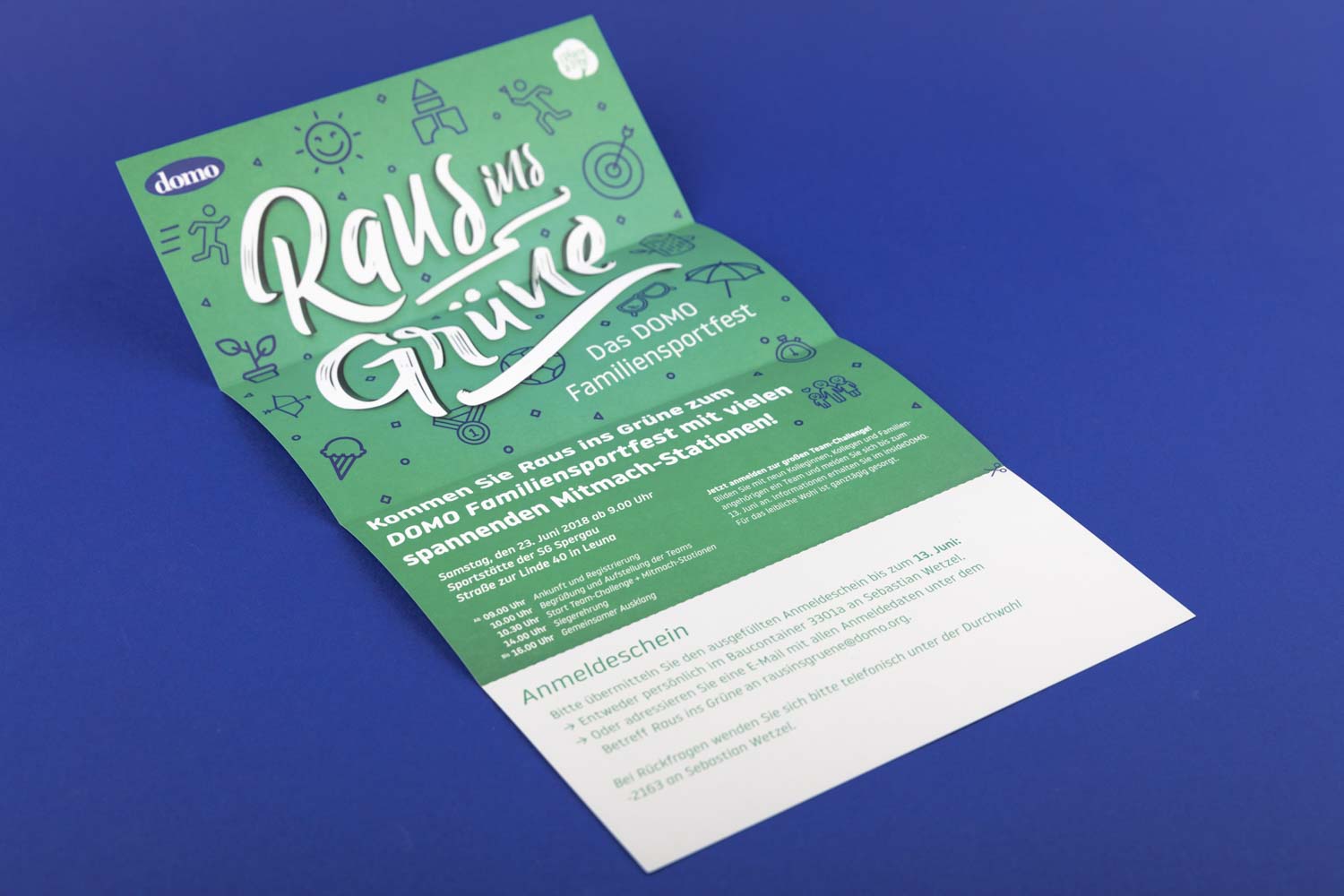 Die grüne, faltbare Save-the-Date Karte für das DOMO Familien-Sportfest im integrierten Event-Design.